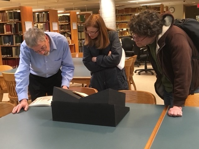 Librarian Jeffrey Marshall (left), English Professor Jenny Sisk (center) and Classics Professor John Franklin (right) examine a sixteenth-century manuscript.